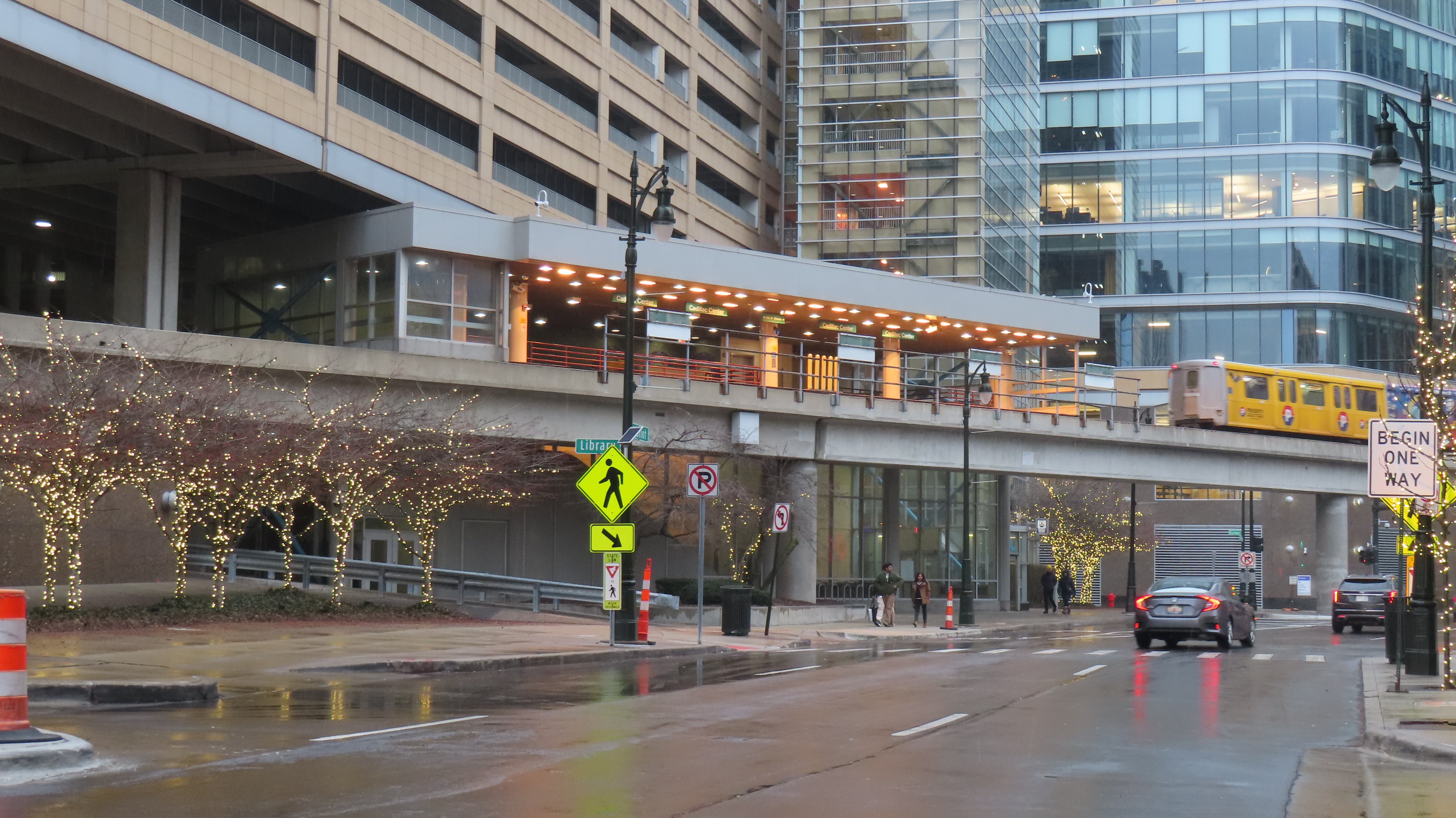 A two-car Detroit People Mover train leaving the elevated Cadillac Center station in downtown Detroit