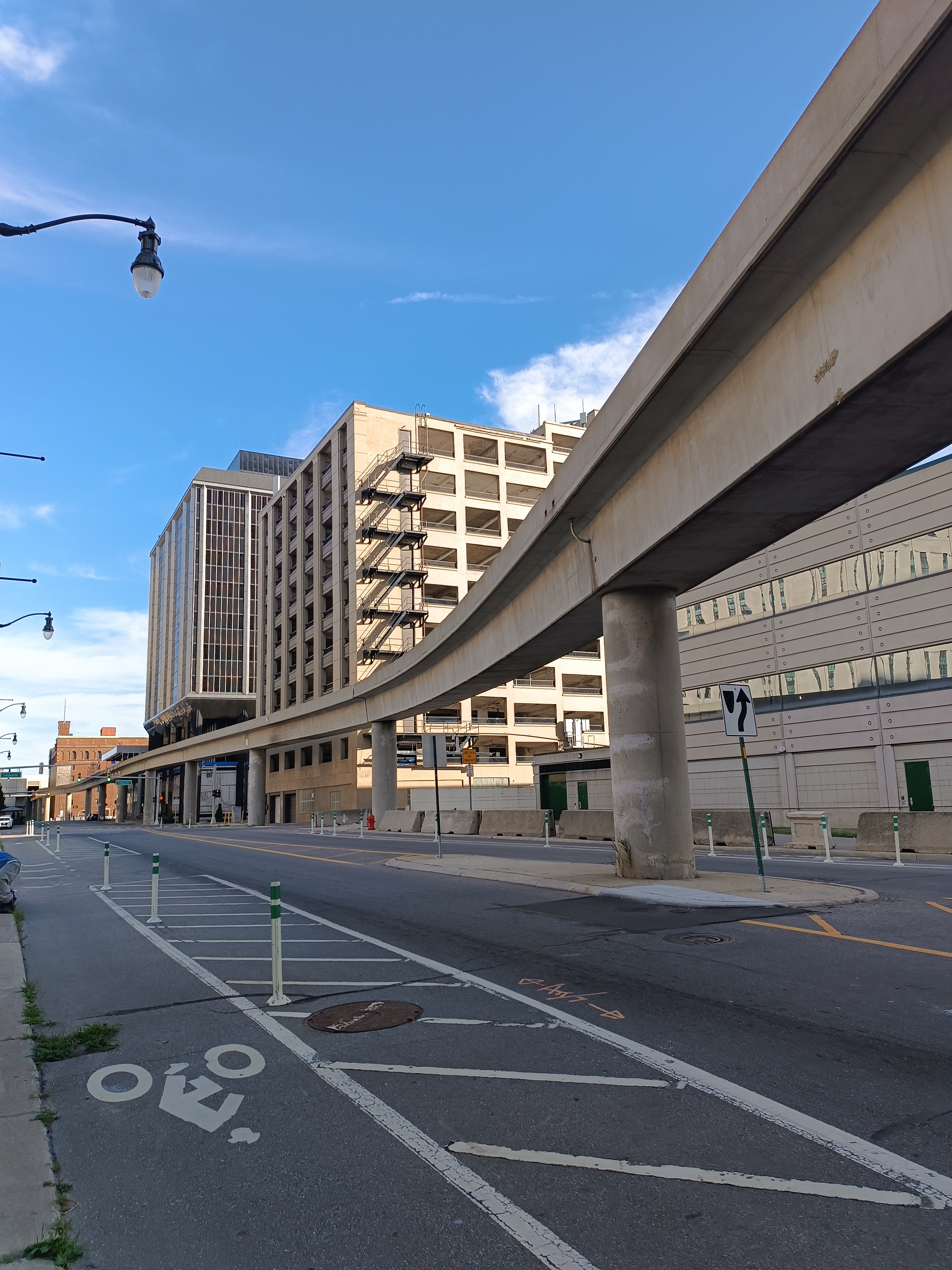 The Detroit People Mover's elevated concrete guideway on pillars above a downtown street